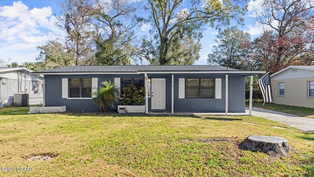 ranch-style home featuring a front yard and central AC unit