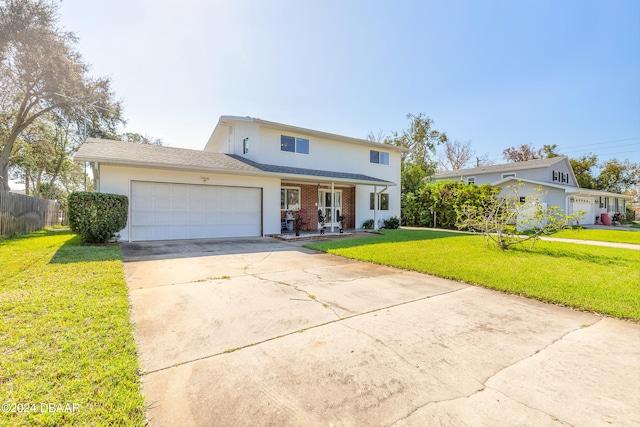 front of property featuring a front lawn, covered porch, and a garage