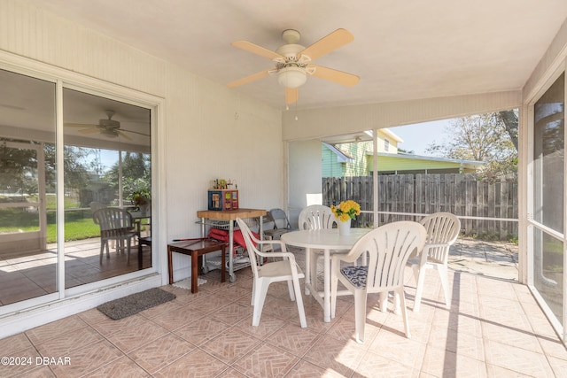 sunroom / solarium with ceiling fan and a healthy amount of sunlight