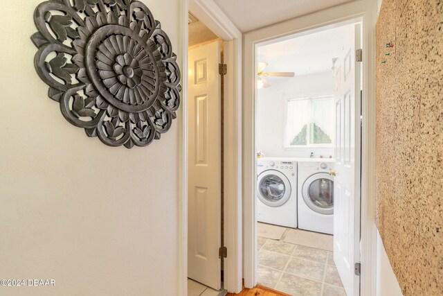 washroom with light tile patterned floors, washer and clothes dryer, and ceiling fan