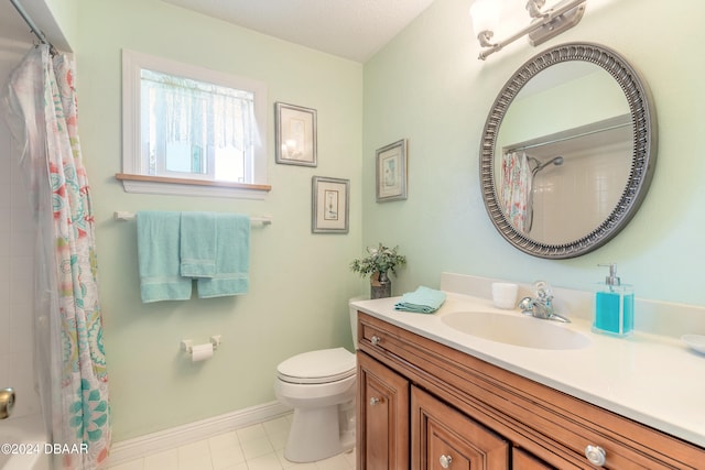 bathroom featuring tile patterned flooring, vanity, toilet, and walk in shower