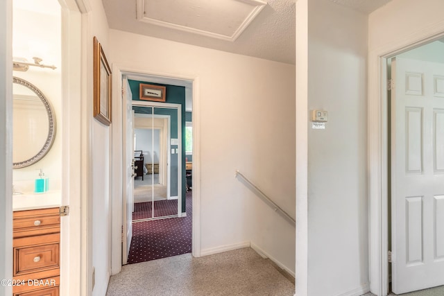 hallway featuring a textured ceiling