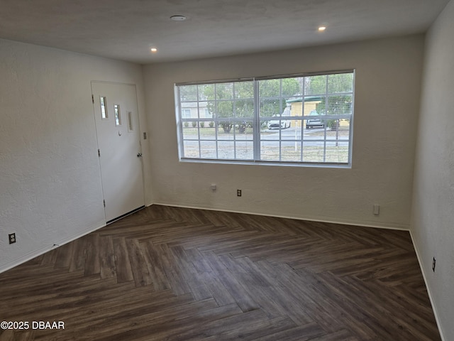 foyer featuring dark parquet flooring