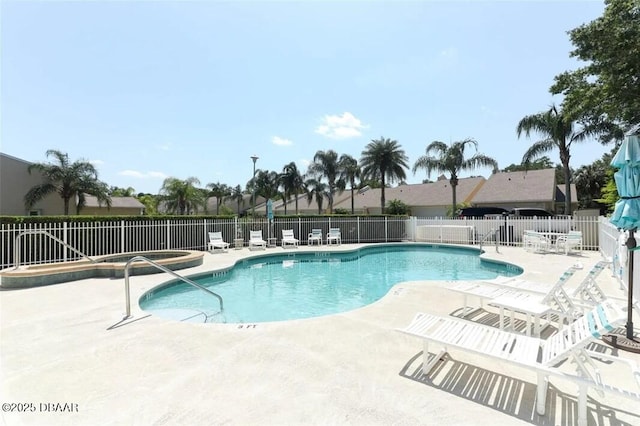 community pool featuring a patio and fence