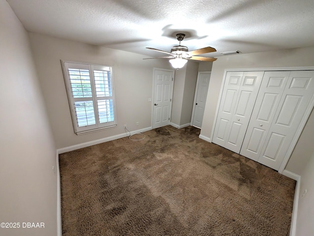 unfurnished bedroom featuring carpet, visible vents, baseboards, and a textured ceiling