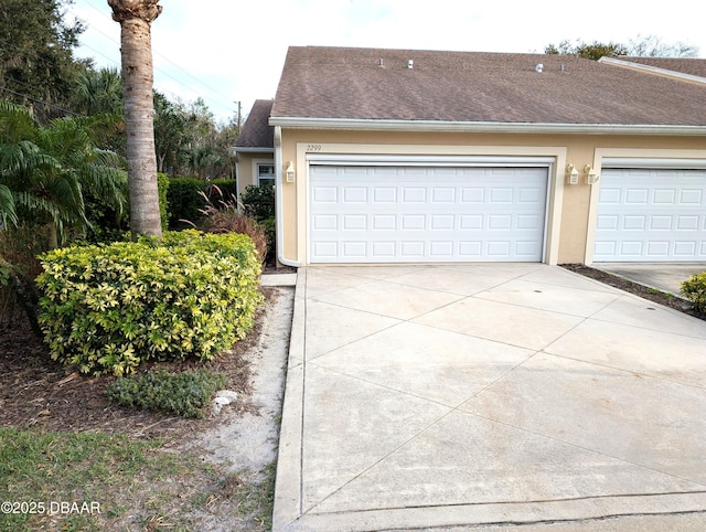 garage featuring concrete driveway