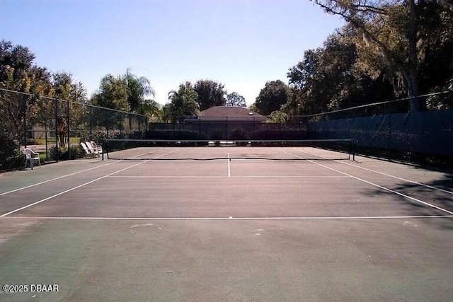 view of sport court featuring fence