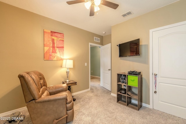 living area featuring light carpet, visible vents, and baseboards