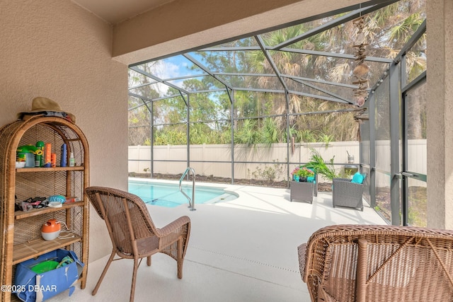 view of swimming pool with glass enclosure, a fenced in pool, a fenced backyard, and a patio area