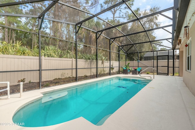 view of swimming pool featuring a patio area, a fenced in pool, glass enclosure, and a fenced backyard