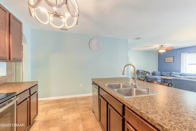 kitchen featuring a sink, stainless steel appliances, brown cabinets, and visible vents