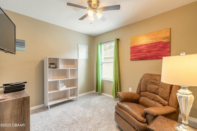 sitting room with baseboards, a ceiling fan, and carpet flooring