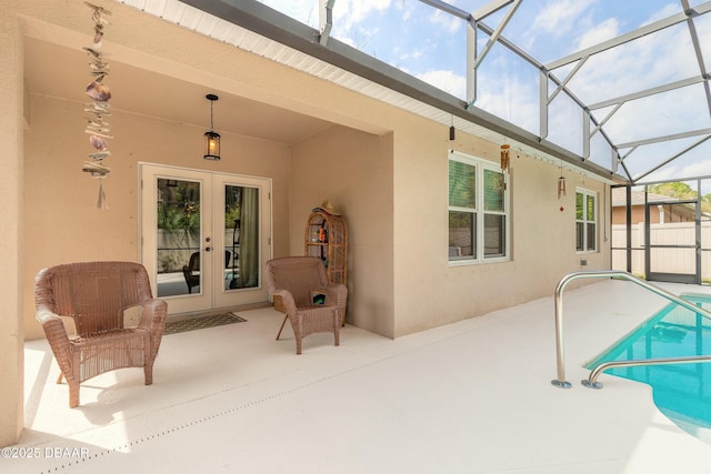 pool with glass enclosure, a patio, and french doors