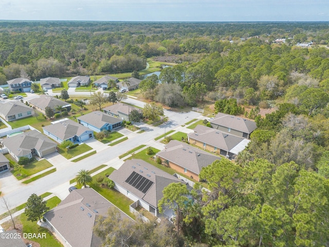 birds eye view of property with a view of trees and a residential view