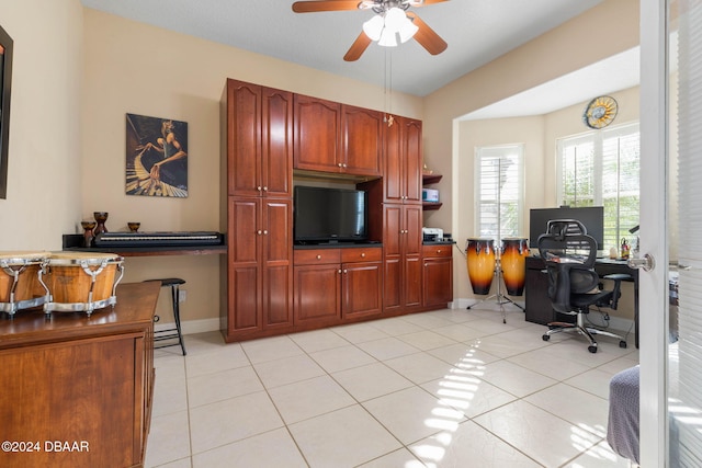 tiled home office featuring ceiling fan