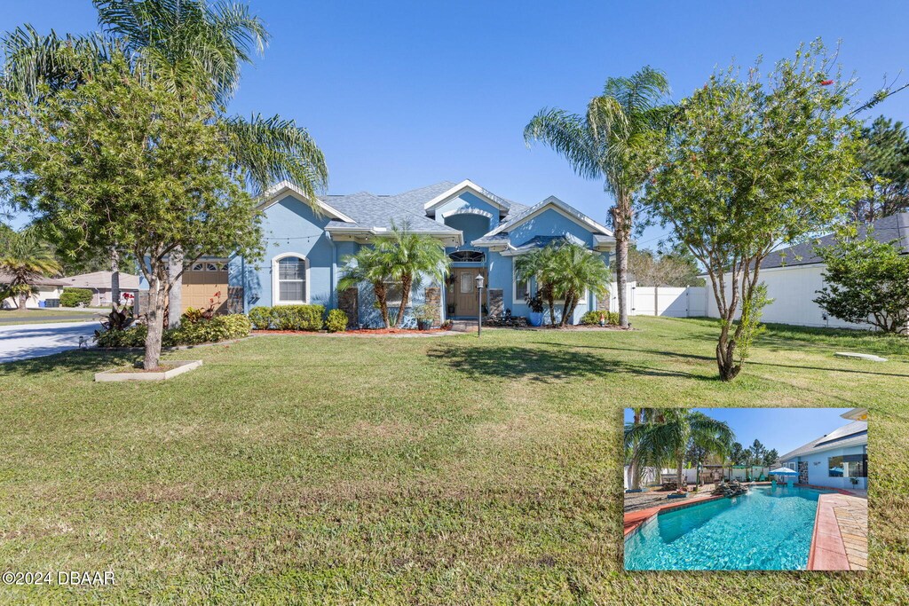 63 Langdon Dr, Palm Coast, FL 32137 - view of front of home featuring an outdoor pool and stucco siding