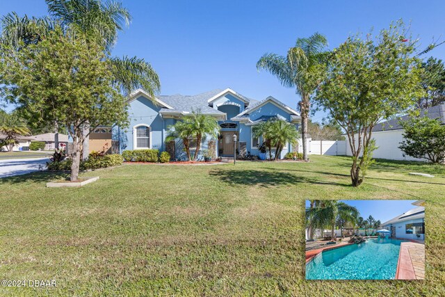 63 Langdon Dr, Palm Coast, FL 32137 - view of front of home featuring an outdoor pool and stucco siding
