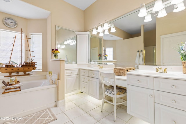 bathroom with tile patterned floors, a bathtub, and vanity