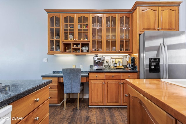 kitchen with dishwasher, stainless steel fridge with ice dispenser, dark hardwood / wood-style flooring, and built in desk