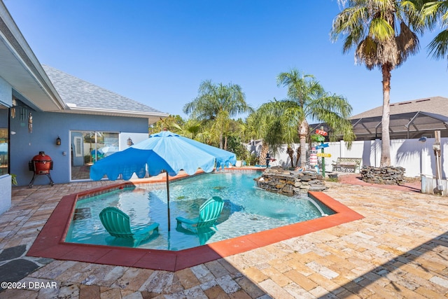 view of swimming pool featuring pool water feature and a patio area