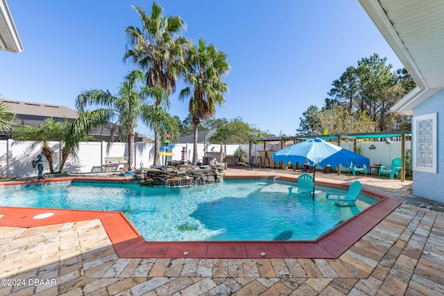 view of pool with pool water feature and a patio