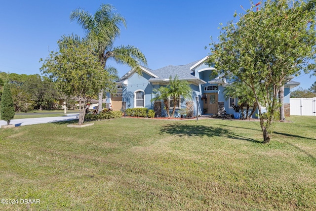 obstructed view of property with a front yard