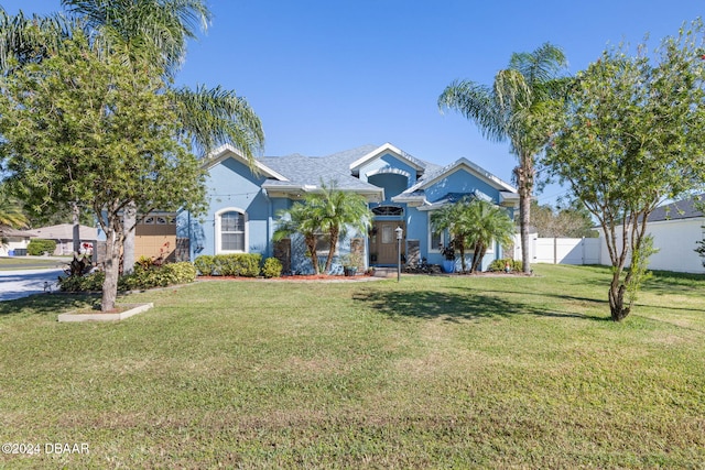 view of front of house featuring a garage and a front yard