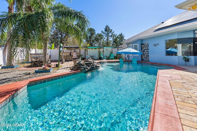 view of swimming pool featuring pool water feature and a patio area