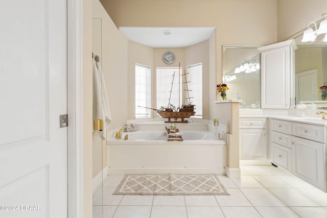 bathroom with tile patterned flooring, vanity, and a tub