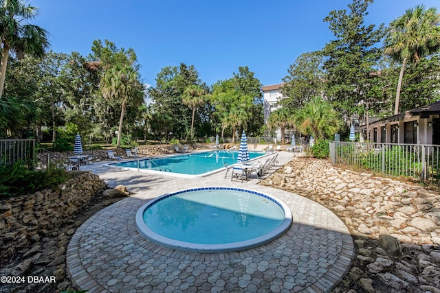 640 N Nova Rd Unit 104, Ormond Beach, FL 32174 - community pool featuring a patio and view of scattered trees