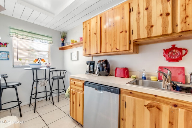 kitchen featuring dishwasher, light tile patterned flooring, light brown cabinets, and sink