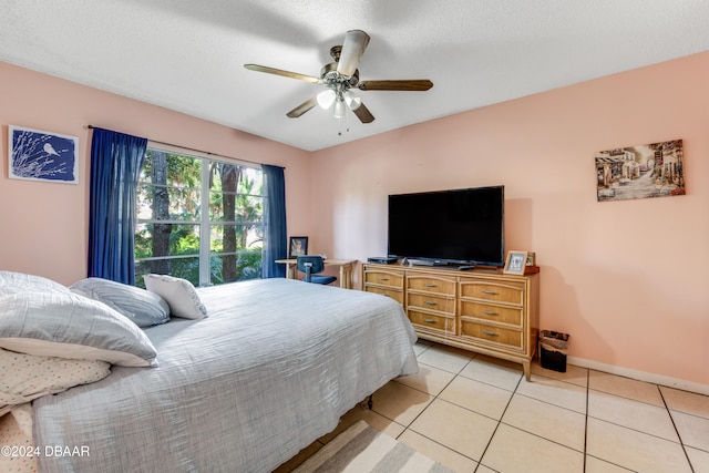 tiled bedroom featuring a textured ceiling and ceiling fan