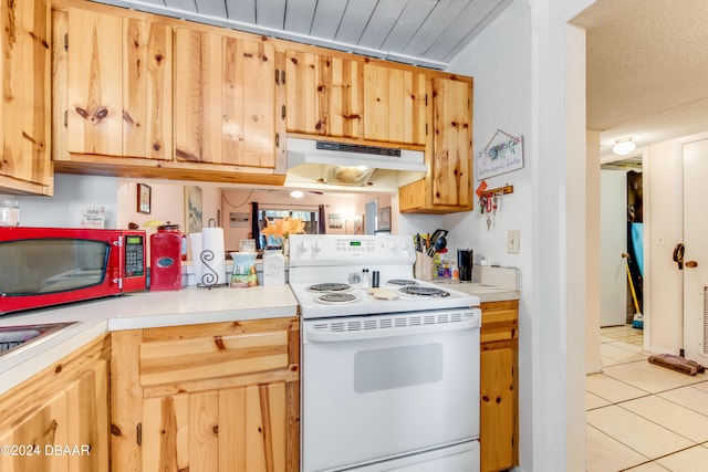 kitchen with light tile patterned floors and white electric stove