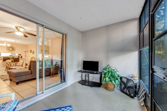 sunroom / solarium featuring ceiling fan