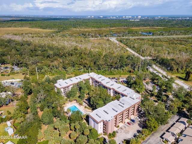 640 N Nova Rd Unit 104, Ormond Beach, FL 32174 - aerial view of property and surrounding area featuring a heavily wooded area and a pool area
