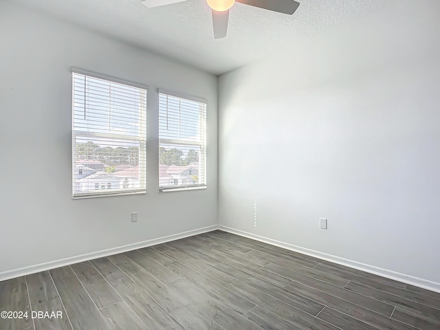 spare room featuring a textured ceiling, dark hardwood / wood-style flooring, and ceiling fan