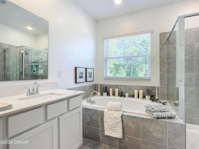 bathroom featuring vanity and separate shower and tub