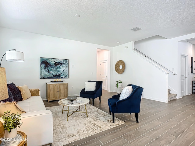 living room with a textured ceiling