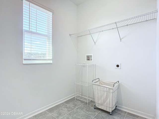 laundry room with electric dryer hookup, tile patterned floors, and hookup for a washing machine