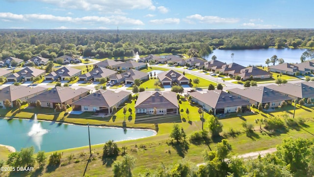 birds eye view of property featuring a forest view, a residential view, and a water view