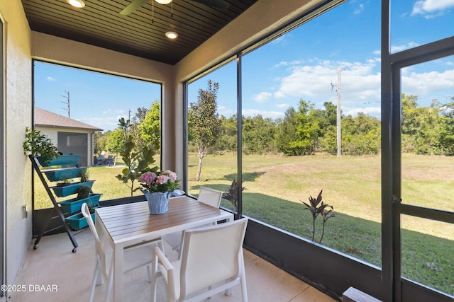 sunroom featuring outdoor dining space and ceiling fan