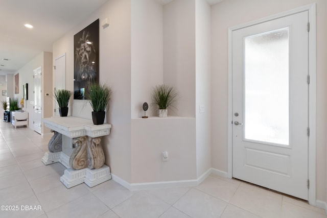 foyer entrance with baseboards and light tile patterned floors
