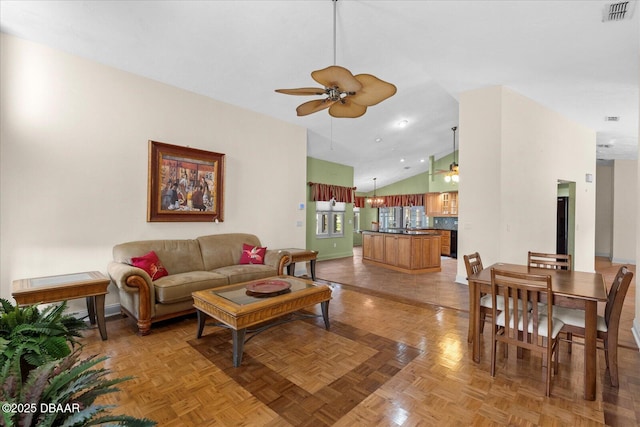 living room with lofted ceiling, visible vents, a ceiling fan, and baseboards