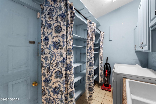washroom with cabinet space and tile patterned floors
