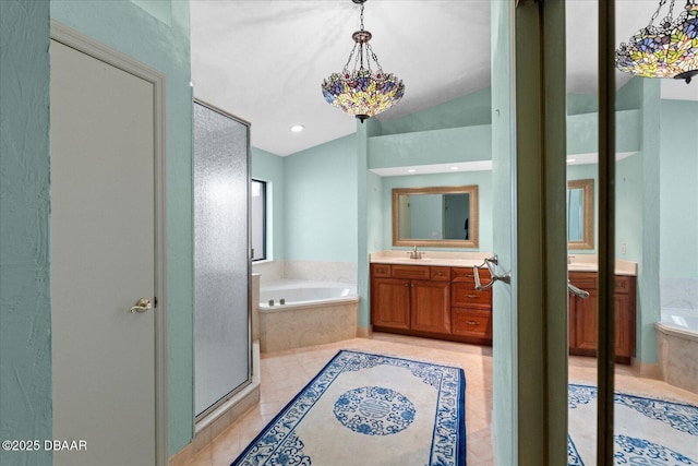 bathroom featuring a shower stall, tile patterned floors, a bath, vanity, and lofted ceiling