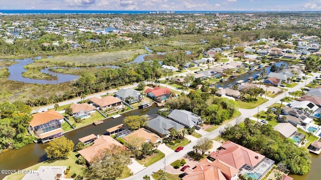 drone / aerial view featuring a residential view and a water view