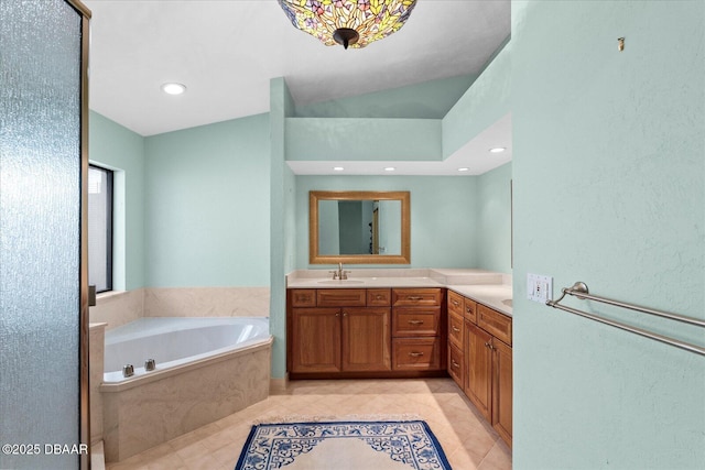 full bath featuring recessed lighting, a garden tub, tile patterned floors, and vanity