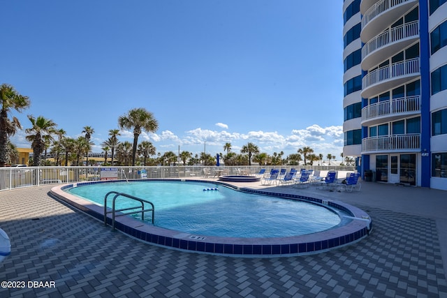 view of swimming pool featuring a patio area