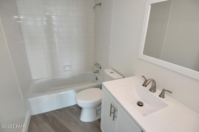 full bathroom featuring toilet, tiled shower / bath combo, vanity, and wood-type flooring