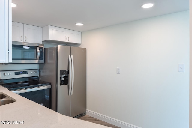 kitchen with white cabinetry and stainless steel appliances